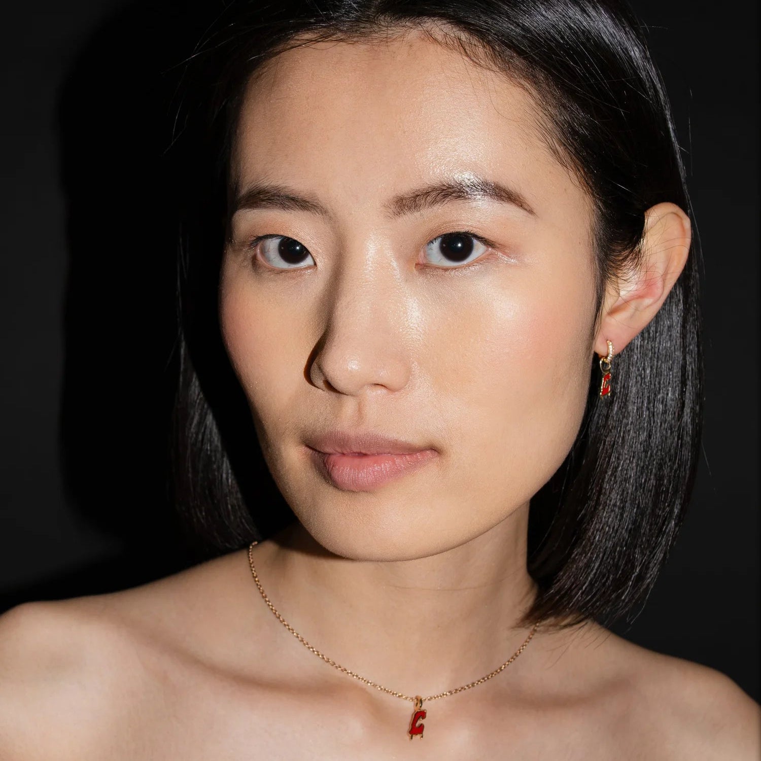 Woman with a necklace against a dark background