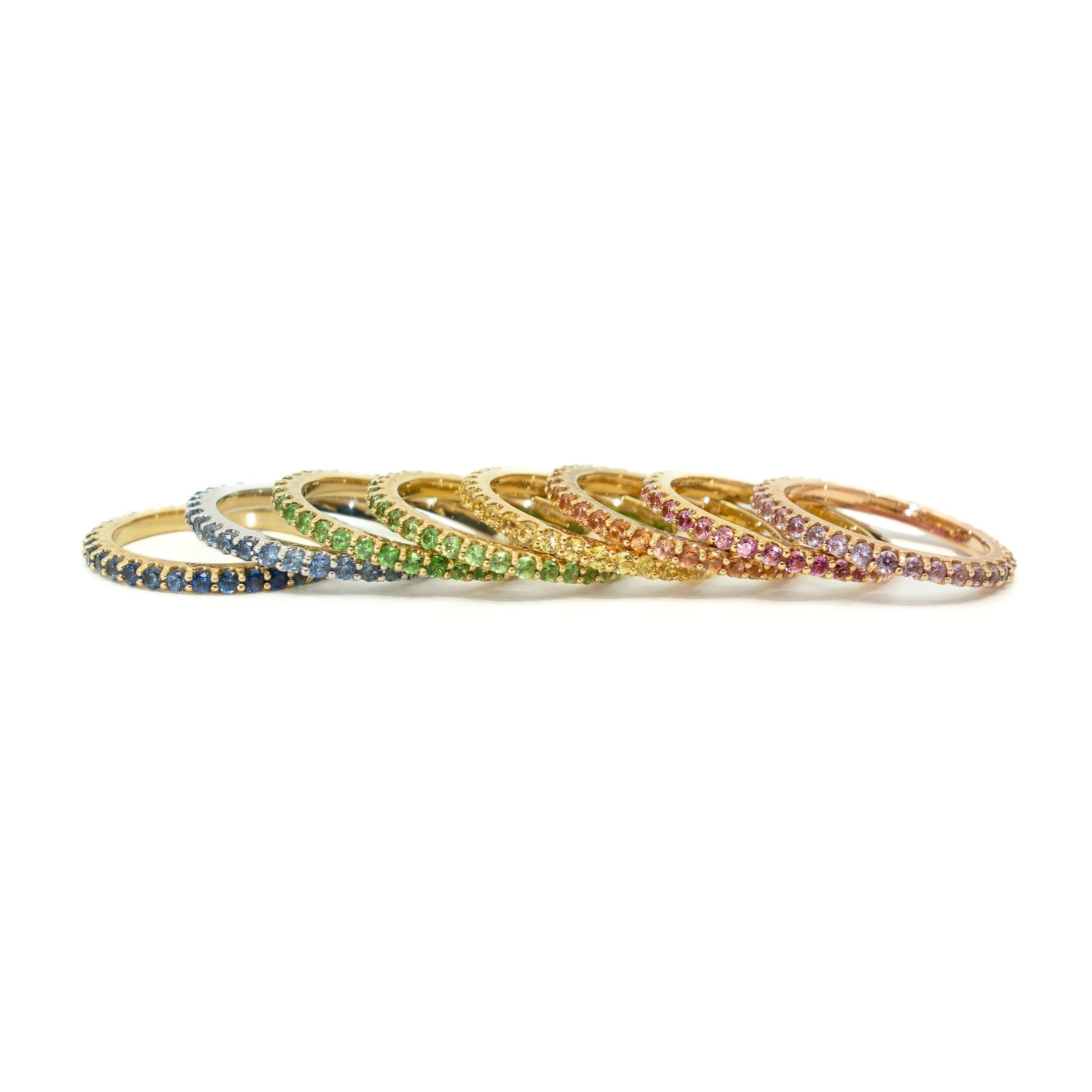Set of colorful gemstone rings on a white background