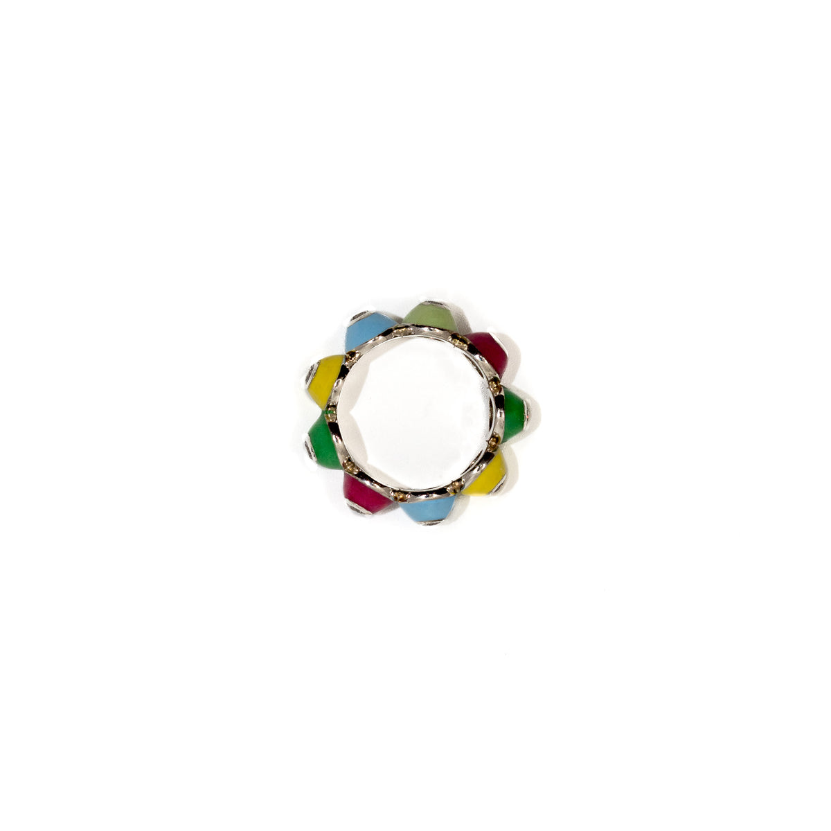 A circular ring with a silver-toned metal frame and colorful enamel segments in yellow, green, blue, and magenta, photographed on a solid white background.