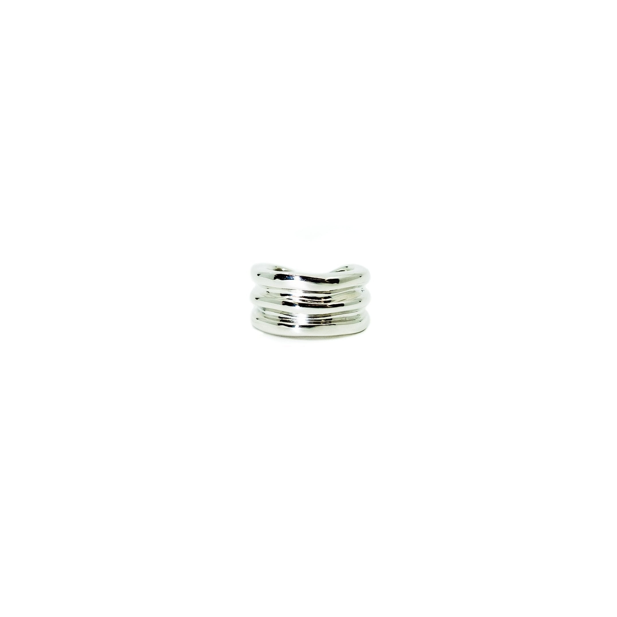 A single 18K white gold ear cuff against a white background.