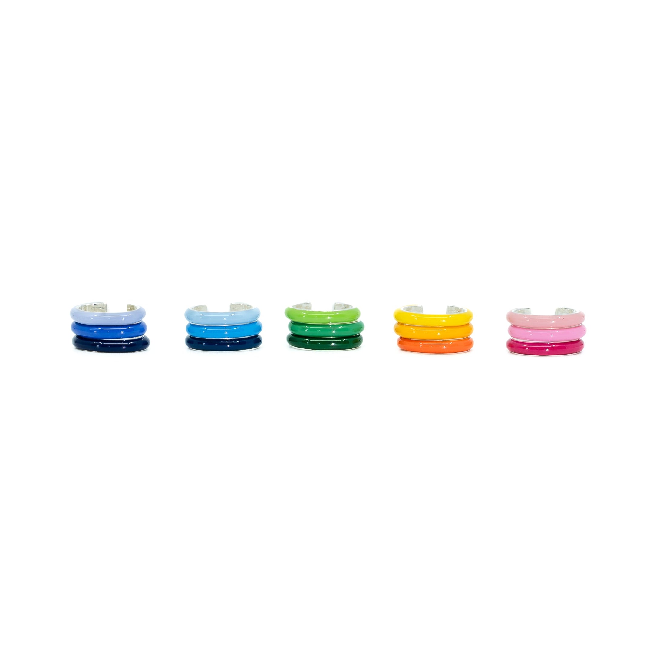 A set of three multicolored ombre enamel ear cuffs, displayed in a row, with colors transitioning from pink to purple.