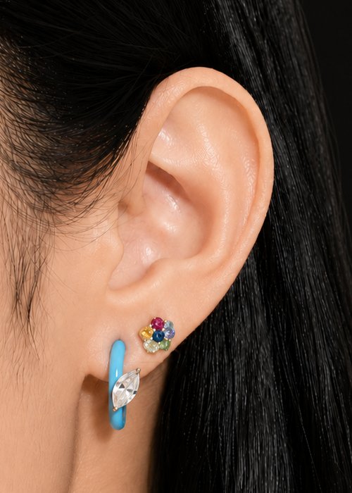 Close-up of an ear wearing the Gem + Enamel Hoop in Cloudless Sky Blue with the Flower Powers Mini Stud in Sapphire