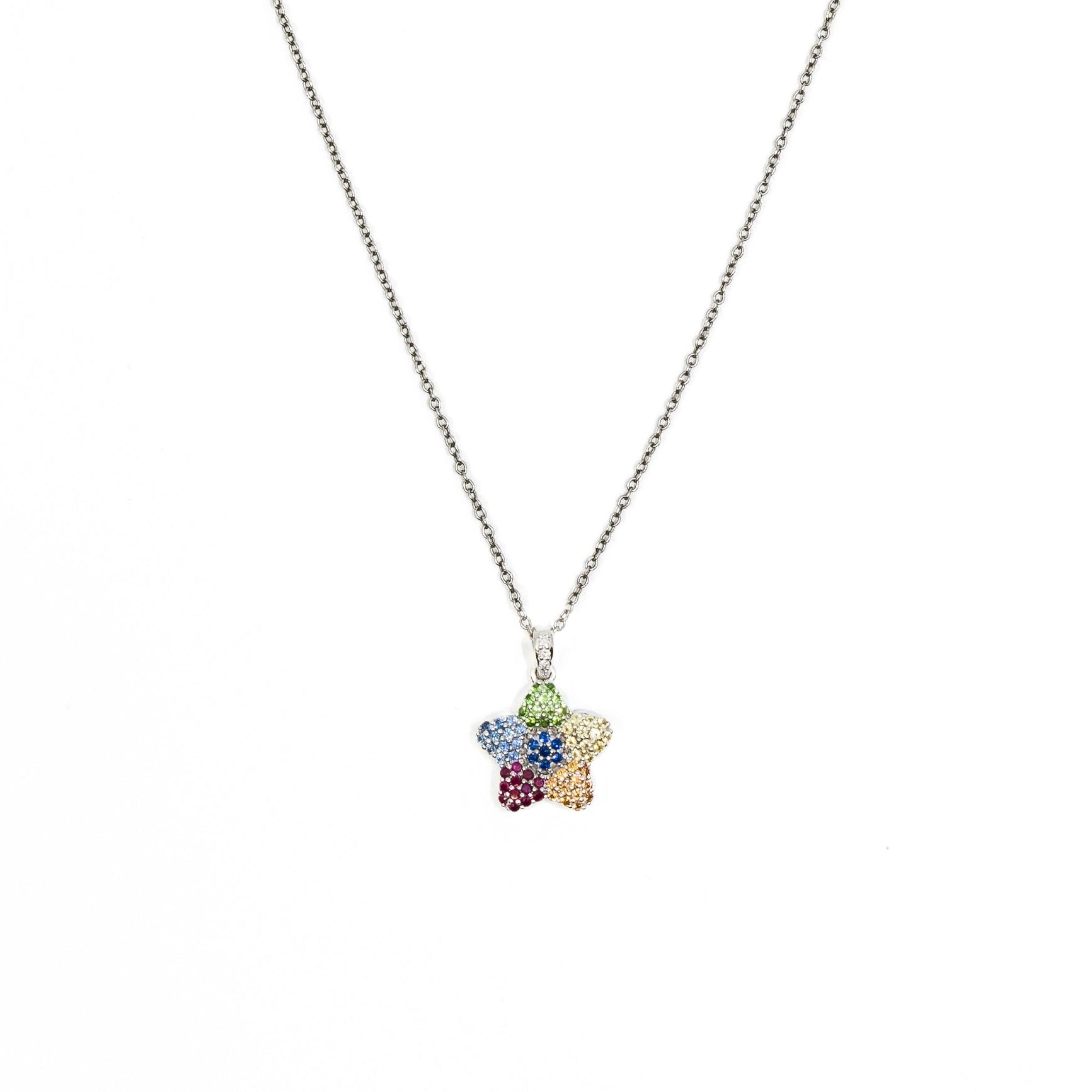 A colorful sapphire charm pendant necklace with a gold chain and a flower-shaped pendant.