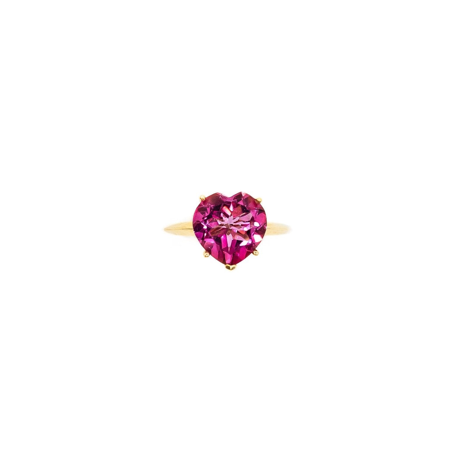 A heart-cut pink tourmaline gemstone set in a 14k gold ring.