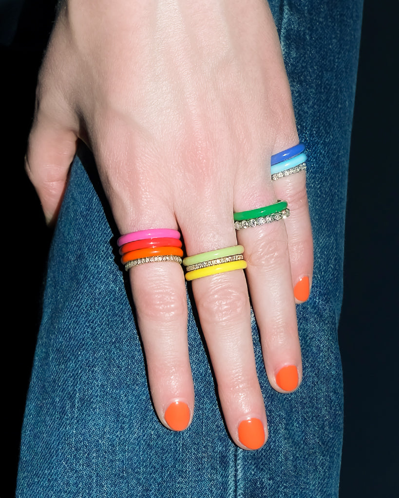Model wears FRY POWERS Complete Set of 8 Rainbow Enamel Stacking Rings