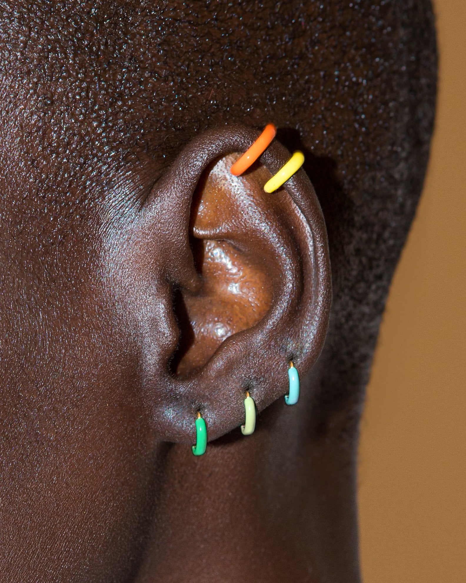 The Neon Enamel Huggies in 14K Gold