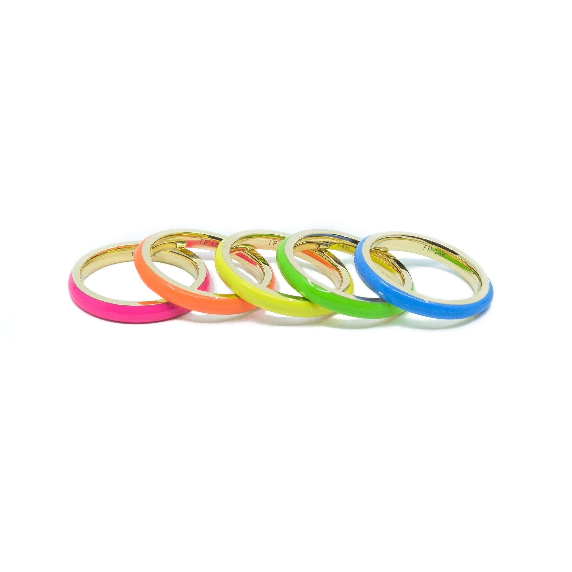 A set of five neon enamel stacking rings in colors pink, orange, yellow, green, and blue, stacked together.