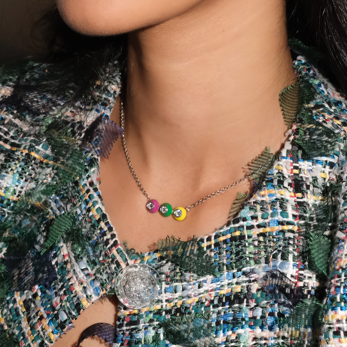 Close-up of a model wearing a POWERS POP enamel and gemstone bar necklace.