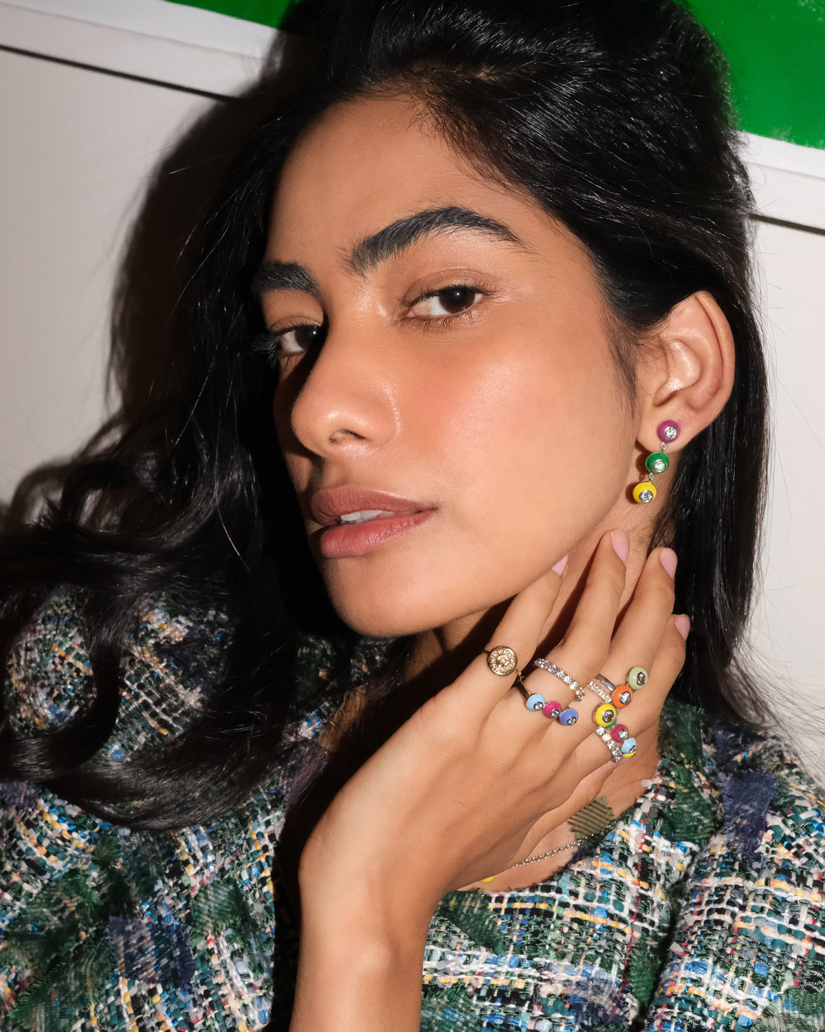 Model wearing colorful POWERS POP enamel and gemstone earrings and rings.