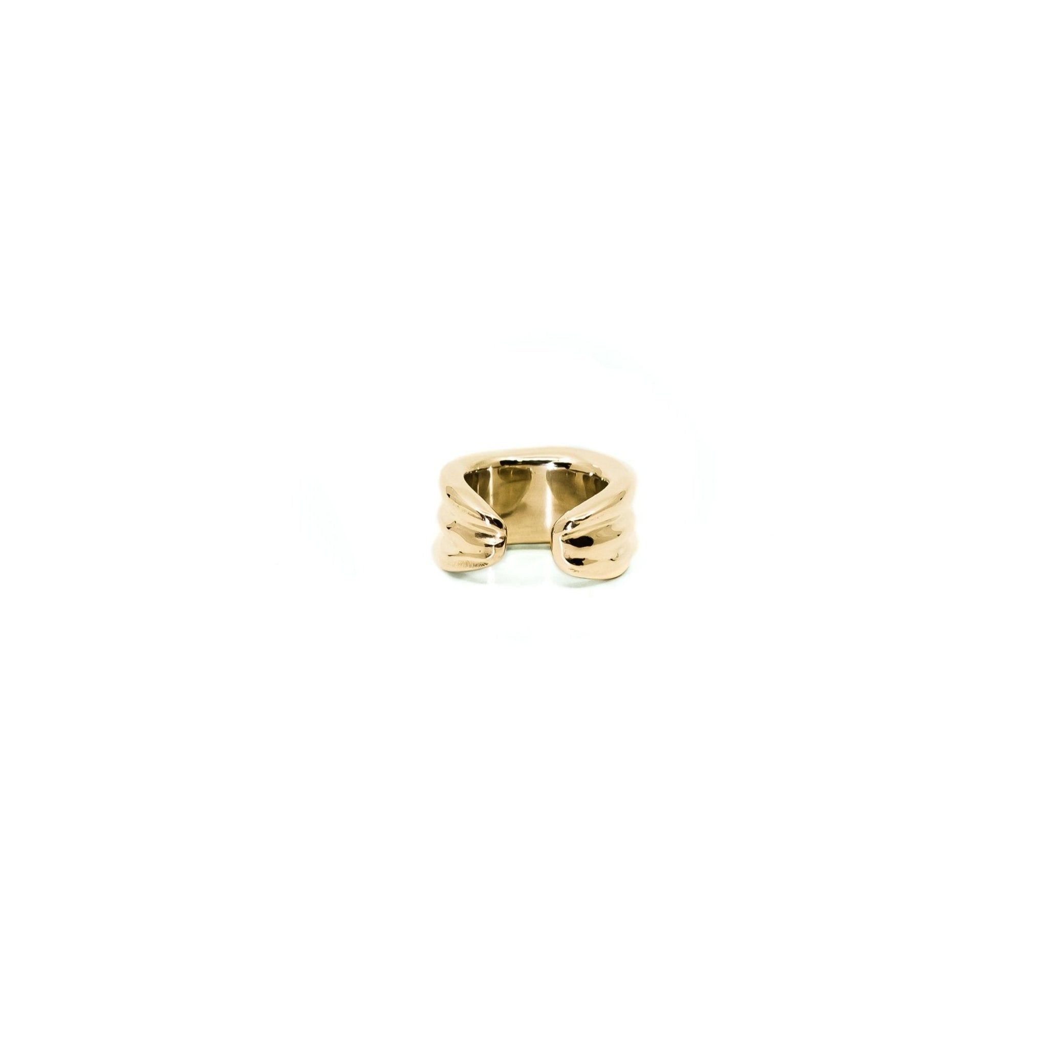 An 18k yellow gold ear cuff earring with a textured, ribbed band and a small bow detail at the center, shown on a plain white background.