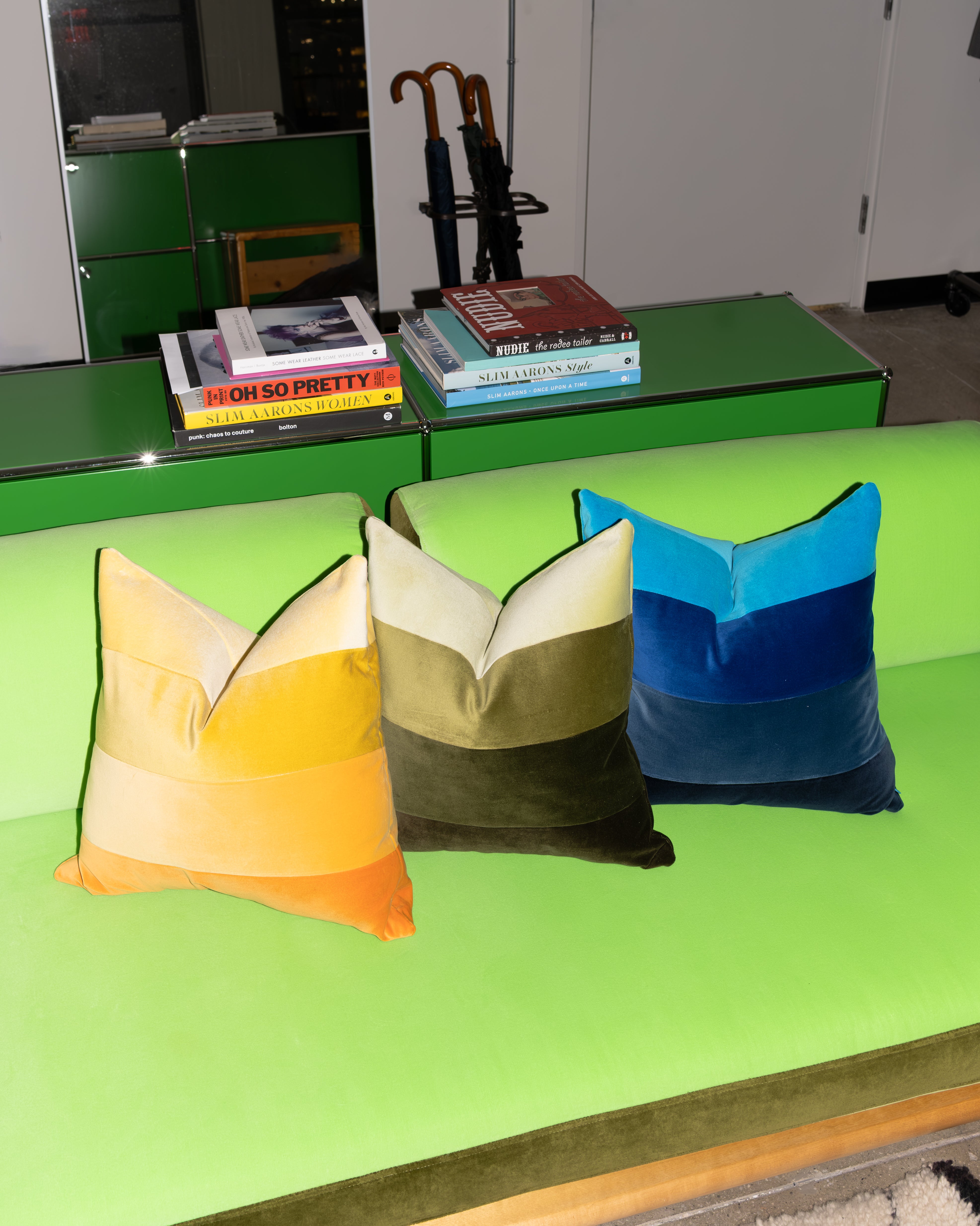 Color-block pillows on a bright green sofa