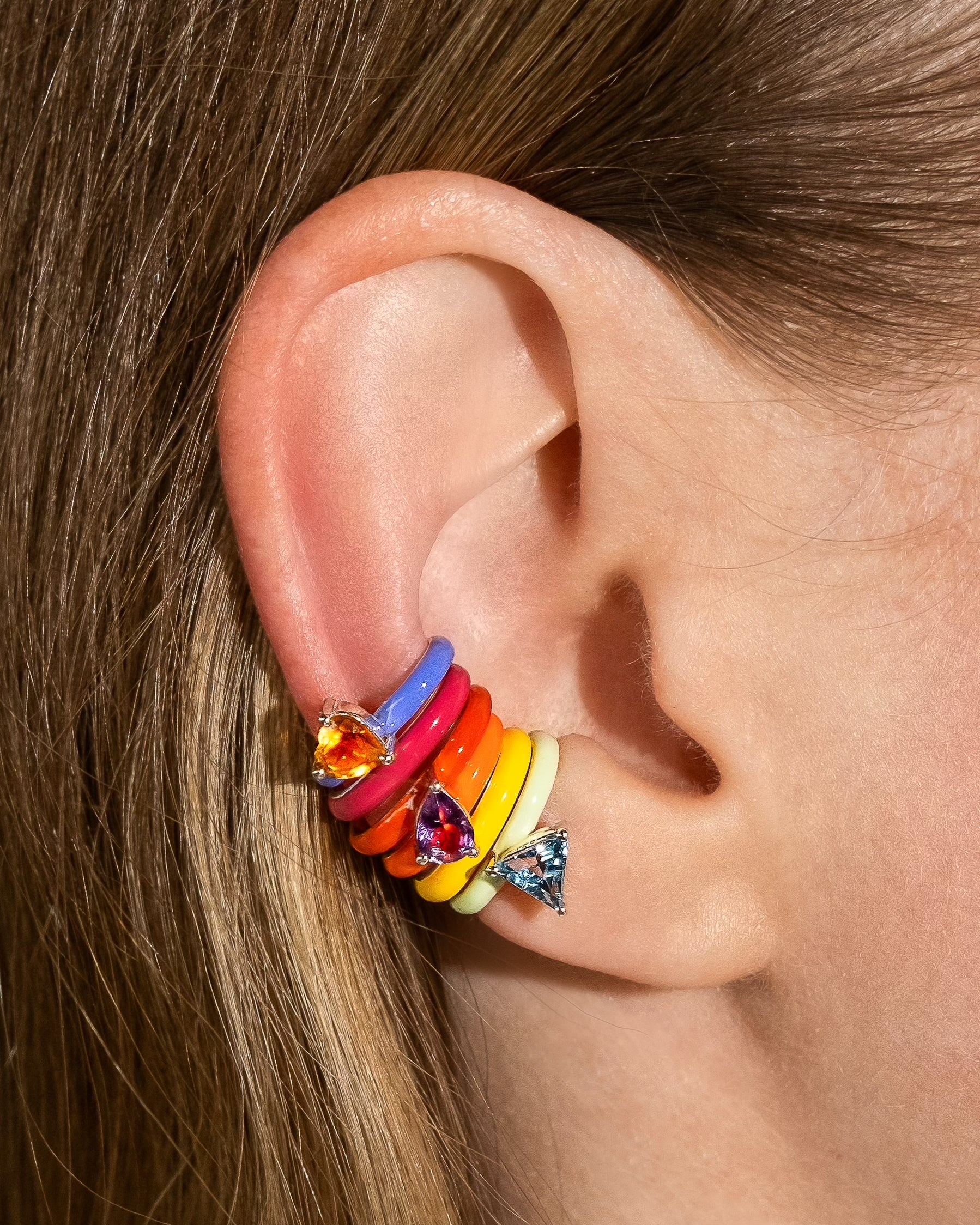 Model wearing colorful FRY POWERS ear cuffs with gemstones