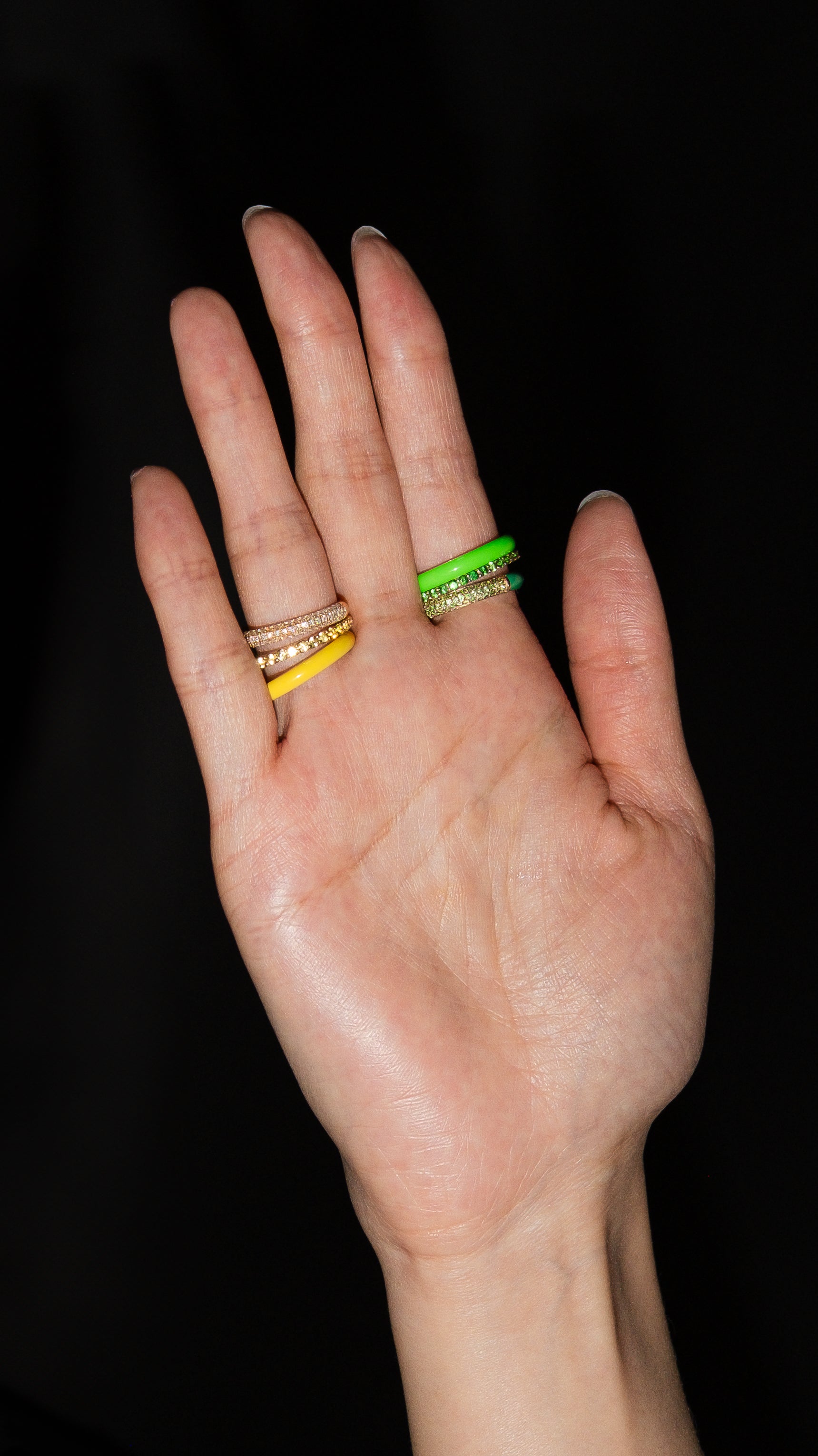 FRY POWERS enamel and pavé rings stacked on a hand