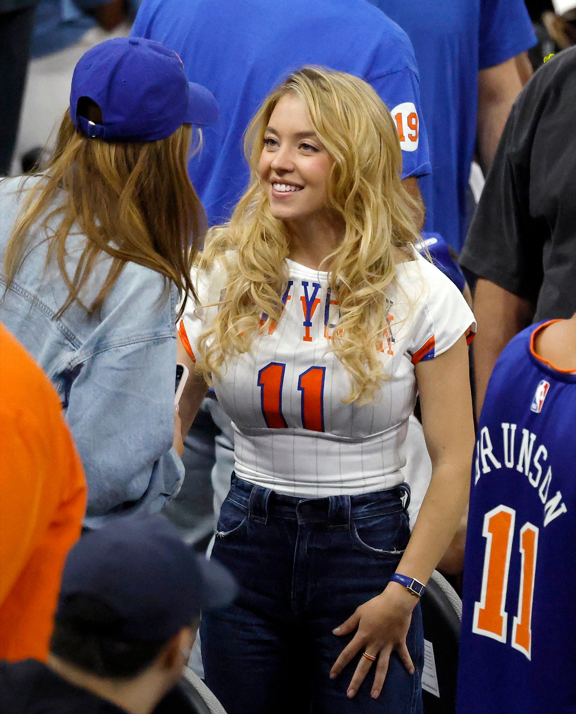 Sydney Sweeney wearing orange enamel and diamond FRY POWERS rings at NBA Finals Game 5