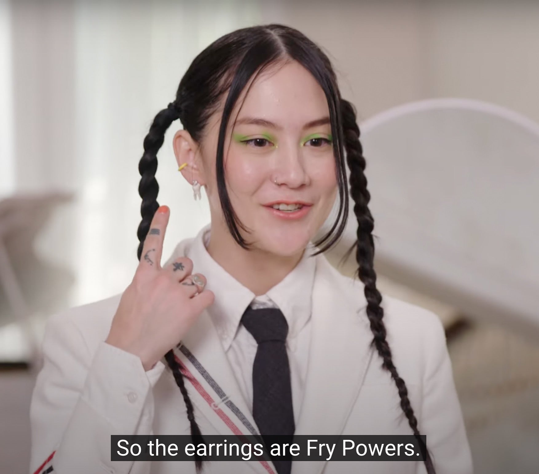 Michelle Zauner pointing to FRY POWERS earrings during Vogue’s 7 Days, 7 Looks video.